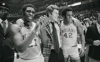 (Original Caption) Indiana coach Bobby Knight, center, is walked off the court in jubilation by a tearful Quinn Buckner, left, and Scott May after the Hoosiers won the NCAA championships in Philadelphia.