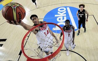454505358 US centre Anthony Davis (L) scores beside US forward Kenneth Faried (C) and New Zealand's forward Isaac Fotu (R) during the 2014 FIBA World basketball championships group C match USA vs New Zealand at the Bizkaia Arena in Bilbao on September 2, 2014. AFP PHOTO / RAFA RIVAS (Photo credit should read RAFA RIVAS/AFP via Getty Images)