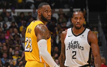 LOS ANGELES, CA - DECEMBER 25: LeBron James #23 of the Los Angeles Lakers and Kawhi Leonard #2 of the LA Clippers walk up court on December 25, 2019 at STAPLES Center in Los Angeles, California. NOTE TO USER: User expressly acknowledges and agrees that, by downloading and/or using this Photograph, user is consenting to the terms and conditions of the Getty Images License Agreement. Mandatory Copyright Notice: Copyright 2019 NBAE (Photo by Andrew D. Bernstein/NBAE via Getty Images)