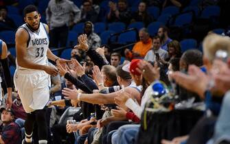 MINNEAPOLIS, MN - OCTOBER 19: Karl-Anthony Towns #32 of the Minnesota Timberwolves high-fives fans after a play against the Memphis Grizzlies during the preseason game on October 19, 2016 at Target Center in Minneapolis, Minnesota. NOTE TO USER: User expressly acknowledges and agrees that, by downloading and or using this Photograph, user is consenting to the terms and conditions of the Getty Images License Agreement. (Photo by Hannah Foslien/Getty Images)