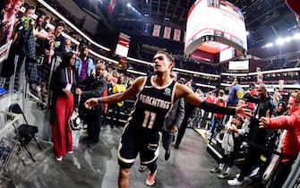 ATLANTA, GA - DECEMBER 2: Trae Young #11 of the Atlanta Hawks hi-fives fans after the game against the Golden State Warriors on December 2, 2019 at State Farm Arena in Atlanta, Georgia. NOTE TO USER: User expressly acknowledges and agrees that, by downloading and/or using this Photograph, user is consenting to the terms and conditions of the Getty Images License Agreement. Mandatory Copyright Notice: Copyright 2019 NBAE (Photo by Scott Cunningham/NBAE via Getty Images)