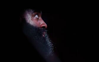 HOUSTON, TEXAS - MARCH 10: A spotlight shines on James Harden #13 of the Houston Rockets as he reacts on the bench during a timeout in the second half against the Minnesota Timberwolves at Toyota Center on March 10, 2020 in Houston, Texas.  NOTE TO USER: User expressly acknowledges and agrees that, by downloading and or using this photograph, User is consenting to the terms and conditions of the Getty Images License Agreement. (Photo by Tim Warner/Getty Images)