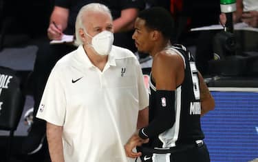 Aug 11, 2020; Lake Buena Vista, Florida, USA; San Antonio Spurs head coach Gregg Popovich (left) talks with guard Dejounte Murray (5) during a break in play during the first half of a NBA basketball game against the Houston Rockets at The Field House. Mandatory Credit: Kim Klement-USA TODAY Sports
