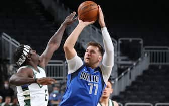 MILWAUKEE, WI - December 12: Luka Doncic #77 of the Dallas Mavericks shoots the ball during a preseason game  against the Milwaukee Bucks on December 12, 2020 at the Fiserv Forum Center in Milwaukee, Wisconsin. NOTE TO USER: User expressly acknowledges and agrees that, by downloading and or using this Photograph, user is consenting to the terms and conditions of the Getty Images License Agreement. Mandatory Copyright Notice: Copyright 2020 NBAE (Photo by Gary Dineen/NBAE via Getty Images).