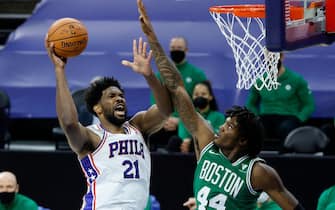 PHILADELPHIA, PENNSYLVANIA - DECEMBER 15: Joel Embiid #21 of the Philadelphia 76ers elevates for a lay up during the first quarter past Robert Williams III #44 of the Boston Celtics at Wells Fargo Center on December 15, 2020 in Philadelphia, Pennsylvania. NOTE TO USER: User expressly acknowledges and agrees that, by downloading and/or using this photograph, user is consenting to the terms and conditions of the Getty Images License Agreement. (Photo by Tim Nwachukwu/Getty Images)