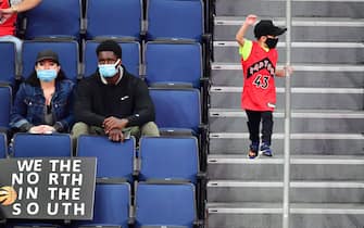 TAMPA, FLORIDA - DECEMBER 23: A young Toronto Raptors fan cheers during the second half of a game against the New Orleans Pelicans at Amalie Arena on December 23, 2020 in Tampa, Florida. NOTE TO USER: User expressly acknowledges and agrees that, by downloading and or using this photograph, User is consenting to the terms and conditions of the Getty Images License Agreement. (Photo by Julio Aguilar/Getty Images)