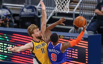 INDIANAPOLIS, IN - DECEMBER 23: Domantas Sabonis #11 of the Indiana Pacers defends against the shot of RJ Barrett #9 of the New York Knicks at Bankers Life Fieldhouse on December 23, 2020 in Indianapolis, Indiana. (Photo by Michael Hickey/Getty Images)