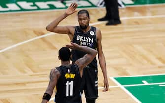 BOSTON, MASSACHUSETTS - DECEMBER 25: Kevin Durant #7 and Kyrie Irving #11 of the Brooklyn Nets high-five during the fourth quarter of the game against the Boston Celtics at TD Garden on December 25, 2020 in Boston, Massachusetts.  NOTE TO USER: User expressly acknowledges and agrees that, by downloading and or using this photograph, User is consenting to the terms and conditions of the Getty Images License Agreement. (Photo by Omar Rawlings/Getty Images)