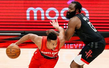 PORTLAND, OREGON - DECEMBER 26: CJ McCollum #3 of the Portland Trail Blazers dribbles past James Harden #13 of the Houston Rockets during overtime at Moda Center on December 26, 2020 in Portland, Oregon. NOTE TO USER: User expressly acknowledges and agrees that, by downloading and/or using this photograph, user is consenting to the terms and conditions of the Getty Images License Agreement. (Photo by Steph Chambers/Getty Images)