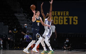 DENVER, CO - December 23: Nikola Jokic #15 of the Denver Nuggets handles the ball during the game against the Sacramento Kings on December 23, 2020 at the Ball Arena in Denver, Colorado. NOTE TO USER: User expressly acknowledges and agrees that, by downloading and/or using this Photograph, user is consenting to the terms and conditions of the Getty Images License Agreement. Mandatory Copyright Notice: Copyright 2020 NBAE (Photo by Garrett Ellwood/NBAE via Getty Images)