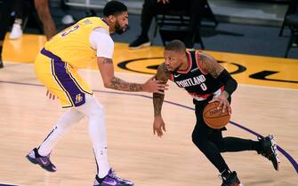 LOS ANGELES, CALIFORNIA - DECEMBER 28: Damian Lillard #0 of the Portland Trail Blazers drives to the basket on Anthony Davis #3 of the Los Angeles Lakers during the first half at Staples Center on December 28, 2020 in Los Angeles, California. NOTE TO USER: User expressly acknowledges and agrees that, by downloading and/or using this photograph, user is consenting to the terms and conditions of the Getty Images License Agreement. (Photo by Harry How/Getty Images)