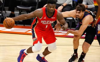 PHOENIX, ARIZONA - DECEMBER 29: Zion Williamson #1 of the New Orleans Pelicans handles the ball under pressure from Dario Saric #20 of the Phoenix Suns during the first half of the NBA game at Phoenix Suns Arena on December 29, 2020 in Phoenix, Arizona.  NOTE TO USER: User expressly acknowledges and agrees that, by downloading and/or using this Photograph, user is consenting to the terms and conditions of the Getty Images License Agreement. Mandatory Copyright Notice: Copyright 2020 NBAE (Photo by Christian Petersen/Getty Images)