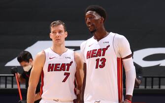 MIAMI, FL - DECEMBER 30: Bam Adebayo #13 & Goran Dragic #7 of the Miami Heat looks on during the game against the Milwaukee Bucks on December 30, 2020 at American Airlines Arena in Miami, Florida. NOTE TO USER: User expressly acknowledges and agrees that, by downloading and or using this Photograph, user is consenting to the terms and conditions of the Getty Images License Agreement. Mandatory Copyright Notice: Copyright 2020 NBAE (Photo by Issac Baldizon/NBAE via Getty Images)