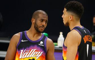 PHOENIX, ARIZONA - DECEMBER 29: Chris Paul #3 of the Phoenix Suns talks with Devin Booker #1 during the second half of the NBA game against the New Orleans Pelicans at Phoenix Suns Arena on December 29, 2020 in Phoenix, Arizona.  NOTE TO USER: User expressly acknowledges and agrees that, by downloading and/or using this Photograph, user is consenting to the terms and conditions of the Getty Images License Agreement. (Photo by Christian Petersen/Getty Images)