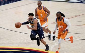 DENVER, COLORADO - JANUARY 01: Jamal Murray #27 of the Denver Nuggets brings the ball down the court against Jae Crowder #99 of the Phoenix Suns after scooping up a lose ball in the third quarter at Ball Arena on January 01, 2021 in Denver, Colorado.  NOTE TO USER: User expressly acknowledges and agrees that, by downloading and or using this photograph, User is consenting to the terms and conditions of the Getty Images License Agreement. (Photo by Matthew Stockman/ Getty Images)