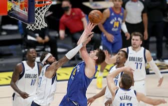 DENVER, COLORADO - JANUARY 07: Nikola Jokic #15 of the Denver Nuggets goes to the basket against Willie Cauley-Stein #33 of the Dallas Mavericks in the fourth quarter at Ball Arena on January 07, 2021 in Denver, Colorado. NOTE TO USER: User expressly acknowledges and agrees that, by downloading and or using this photograph, User is consenting to the terms and conditions of the Getty Images License Agreement (Photo by Matthew Stockman/Getty Images)
