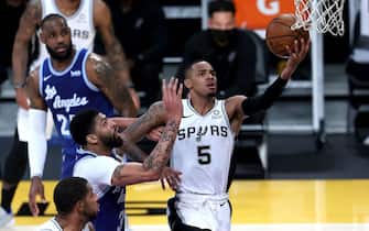 LOS ANGELES, CALIFORNIA - JANUARY 07: Dejounte Murray #5 of the San Antonio Spurs lays up a shot past the defense of Anthony Davis #3 of the Los Angeles Lakers during the second half of a game at Staples Center on January 07, 2021 in Los Angeles, California.  NOTE TO USER: User expressly acknowledges and agrees that, by downloading and or using this photograph, User is consenting to the terms and conditions of the Getty Images License Agreement. (Photo by Sean M. Haffey/Getty Images)