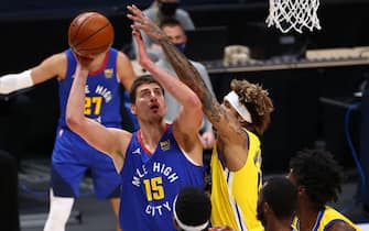 DENVER, CO - DECEMBER 23: Nikola Jokic #15 of the Denver Nuggets drives against Kelly Oubre Jr. #12 of the Golden State Warriors at Ball Arena on December 23, 2020 in Denver, Colorado. NOTE TO USER: User expressly acknowledges and agrees that, by downloading and/or using this photograph, user is consenting to the terms and conditions of the Getty Images License Agreement (Photo by Jamie Schwaberow/Getty Images)