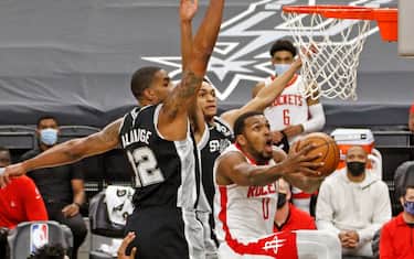 SAN ANTONIO, TX - JANUARY 14:  Sterling Brown #0 of the Houston Rockets drives past LaMarcus Aldridge #12 of the San Antonio Spurs at AT&T Center on January 14, 2021 in San Antonio, Texas.  NOTE TO USER: User expressly acknowledges and agrees that , by downloading and or using this photograph, User is consenting to the terms and conditions of the Getty Images License Agreement. (Photo by Ronald Cortes/Getty Images)