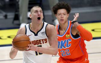 DENVER, COLORADO - JANUARY 19: Nikola Jokic #15 of the Denver Nuggets goes to the basket against Isaiah Roby #22 of the Oklahoma City Thunder in the first quarter at Ball Arena on January 19, 2021 in Denver, Colorado. NOTE TO USER: User expressly acknowledges and agrees that, by downloading and or using this photograph, User is consenting to the terms and conditions of the Getty Images License Agreement (Photo by Matthew Stockman/Getty Images)