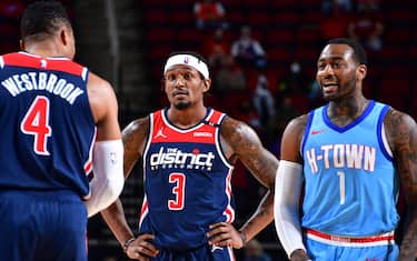 HOUSTON, TX - JANUARY 26: Russell Westbrook #4 and Bradley Beal #3 of the Washington Wizards stand beside former teammate John Wall #1 of the Houston Rockets during the game on January 26, 2021 at the Toyota Center in Houston, Texas. NOTE TO USER: User expressly acknowledges and agrees that, by downloading and or using this photograph, User is consenting to the terms and conditions of the Getty Images License Agreement. Mandatory Copyright Notice: Copyright 2021 NBAE (Photo by Cato Cataldo/NBAE via Getty Images)