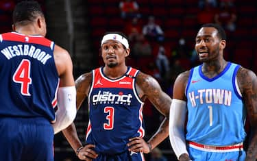 HOUSTON, TX - JANUARY 26:  Russell Westbrook #4 and Bradley Beal #3 of the Washington Wizards stand beside former teammate John Wall #1 of the Houston Rockets during the game on January 26, 2021 at the Toyota Center in Houston, Texas. NOTE TO USER: User expressly acknowledges and agrees that, by downloading and or using this photograph, User is consenting to the terms and conditions of the Getty Images License Agreement. Mandatory Copyright Notice: Copyright 2021 NBAE (Photo by Cato Cataldo/NBAE via Getty Images)