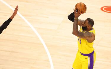 ATLANTA, GEORGIA - FEBRUARY 01: LeBron James #23 of the Los Angeles Lakers shoots a three-point basket against Cam Reddish #22 of the Atlanta Hawks during the second half at State Farm Arena on February 01, 2021 in Atlanta, Georgia. NOTE TO USER: User expressly acknowledges and agrees that, by downloading and or using this photograph, User is consenting to the terms and conditions of the Getty Images License Agreement. (Photo by Kevin C. Cox/Getty Images)