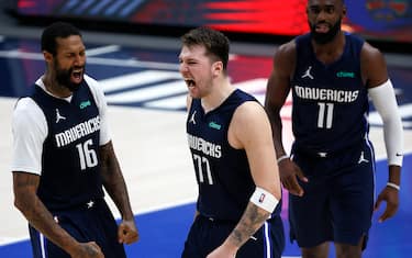 DALLAS, TEXAS - FEBRUARY 23: Luka Doncic #77 of the Dallas Mavericks celebrates with James Johnson #16 of the Dallas Mavericks after making the game-winning shot against the Boston Celtics at American Airlines Center on February 23, 2021 in Dallas, Texas. NOTE TO USER: User expressly acknowledges and agrees that, by downloading and or using this photograph, User is consenting to the terms and conditions of the Getty Images License Agreement. (Photo by Tom Pennington/Getty Images)