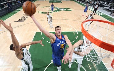 MILWAUKEE, WI - MARCH 2: Nikola Jokic #15 of the Denver Nuggets shoots the ball during the game against the Milwaukee Bucks on March 2, 2021 at the Fiserv Forum Center in Milwaukee, Wisconsin. NOTE TO USER: User expressly acknowledges and agrees that, by downloading and or using this Photograph, user is consenting to the terms and conditions of the Getty Images License Agreement. Mandatory Copyright Notice: Copyright 2021 NBAE (Photo by Gary Dineen/NBAE via Getty Images).