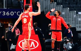 ATLANTA, GA - MARCH 14: Trae Young #11 hi-fives Danilo Gallinari #8 of the Atlanta Hawks during the game against the Cleveland Cavaliers on March 14, 2021 at State Farm Arena in Atlanta, Georgia.  NOTE TO USER: User expressly acknowledges and agrees that, by downloading and/or using this Photograph, user is consenting to the terms and conditions of the Getty Images License Agreement. Mandatory Copyright Notice: Copyright 2021 NBAE (Photo by Scott Cunningham/NBAE via Getty Images)