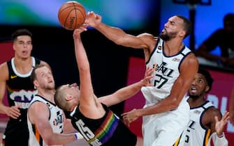 1228112589 LAKE BUENA VISTA, FLORIDA - AUGUST 19: Rudy Gobert #27 of the Utah Jazz blocks a shot by Nikola Jokic #15 of the Denver Nuggets during the first half of Game Two of a first round playoff game at AdventHealth Arena at ESPN Wide World Of Sports Complex on August 19, 2020 in Lake Buena Vista, Florida. NOTE TO USER: User expressly acknowledges and agrees that, by downloading and or using this photograph, User is consenting to the terms and conditions of the Getty Images License Agreement. (Photo by Ashley Landis-Pool/Getty Images)