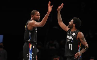 BROOKLYN, NY - APRIL 7: Kevin Durant #7 and Kyrie Irving #11 of the Brooklyn Nets high five during the game against the New Orleans Pelicans on April 7, 2021 at Barclays Center in Brooklyn, New York. NOTE TO USER: User expressly acknowledges and agrees that, by downloading and or using this Photograph, user is consenting to the terms and conditions of the Getty Images License Agreement. Mandatory Copyright Notice: Copyright 2021 NBAE (Photo by Nathaniel S. Butler/NBAE via Getty Images)