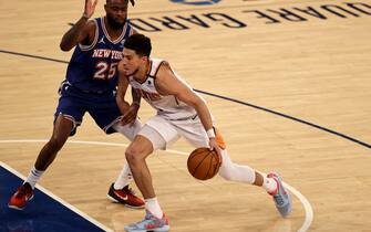 NEW YORK, NEW YORK - APRIL 26: Devin Booker #1 of the Phoenix Suns heads for the net as Reggie Bullock #25 of the New York Knicks defends in the fourth quarter at Madison Square Garden on April 26, 2021 in New York City. NOTE TO USER: User expressly acknowledges and agrees that, by downloading and or using this photograph, User is consenting to the terms and conditions of the Getty Images License Agreement. (Photo by Elsa/Getty Images)