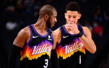 PHOENIX, AZ - FEBRUARY 7: Chris Paul #3 talks with Devin Booker #1 of the Phoenix Suns during the game against the Boston Celtics on February 7, 2021 at Talking Stick Resort Arena in Phoenix, Arizona. NOTE TO USER: User expressly acknowledges and agrees that, by downloading and or using this photograph, user is consenting to the terms and conditions of the Getty Images License Agreement. Mandatory Copyright Notice: Copyright 2021 NBAE (Photo by Barry Gossage/NBAE via Getty Images)
