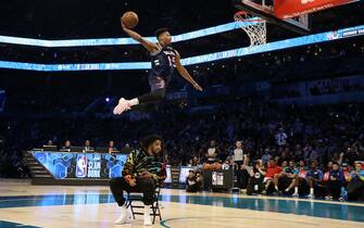 CHARLOTTE, NORTH CAROLINA - FEBRUARY 16: Dennis Smith Jr. #5 of the New York Knicks dunks the ball over over J. Cole during the AT&T Slam Dunk as part of the 2019 NBA All-Star Weekend at Spectrum Center on February 16, 2019 in Charlotte, North Carolina. (Photo by Streeter Lecka/Getty Images)