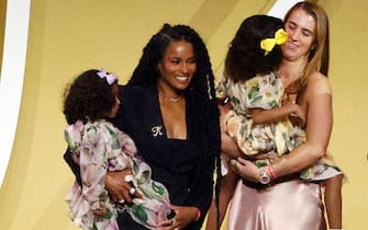 UNCASVILLE, CONNECTICUT - MAY 15: Professional basketball player Sabrina Ionescu and Ciara hold Kobe Bryant's daughters Capri and Bianka on-stage following the 2021 Basketball Hall of Fame Enshrinement Ceremony at Mohegan Sun Arena on May 15, 2021 in Uncasville, Connecticut. (Photo by Maddie Meyer/Getty Images)