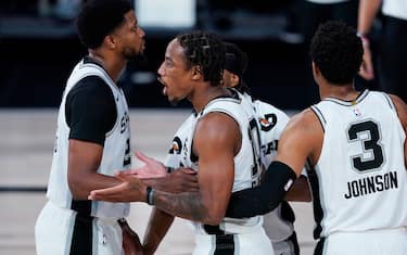 LAKE BUENA VISTA, FLORIDA - AUGUST 02: San Antonio Spurs' DeMar DeRozan, center, reacts after a play against the Memphis Grizzlies during the first half of an NBA basketball game at Visa Athletic Center at ESPN Wide World Of Sports Complex on August 2, 2020 in Lake Buena Vista, Florida. NOTE TO USER: User expressly acknowledges and agrees that, by downloading and or using this photograph, User is consenting to the terms and conditions of the Getty Images License Agreement. (Photo by Ashley Landis-Pool/Getty Images)