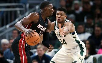 MILWAUKEE, WISCONSIN - OCTOBER 26:  Bam Adebayo #13 of the Miami Heat dribbles the ball while being guarded by Giannis Antetokounmpo #34 of the Milwaukee Bucks in the second quarter at the Fiserv Forum on October 26, 2019 in Milwaukee, Wisconsin. NOTE TO USER: User expressly acknowledges and agrees that, by downloading and/or using this photograph, user is consenting to the terms and conditions of the Getty Images License Agreement. (Photo by Dylan Buell/Getty Images)