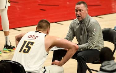 PORTLAND, OR - MAY 29: Nikola Jokic (15) and Denver Nuggets head coach Michael Malone strategize against the Portland Trail Blazers during the first quarter at Moda Center on Saturday, May 29, 2021. (Photo by AAron Ontiveroz/MediaNews Group/The Denver Post via Getty Images)