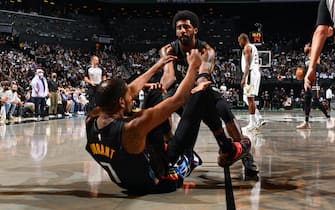 BROOKLYN, NY - JUNE 7: Kyrie Irving #11 of the Brooklyn Nets helps up Kevin Durant #7 of the Brooklyn Nets during Round 2, Game 2 on June 7, 2021 at Barclays Center in Brooklyn, New York. NOTE TO USER: User expressly acknowledges and agrees that, by downloading and/or using this Photograph, user is consenting to the terms and conditions of the Getty Images License Agreement. Mandatory Copyright Notice: Copyright 2021 NBAE (Photo by Jesse D. Garrabrant/NBAE via Getty Images) 