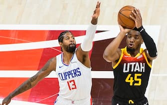 SALT LAKE CITY, UTAH - JUNE 10: Donovan Mitchell #45 of the Utah Jazz shoots over Paul George #13 of the LA Clippers in Game Two of the Western Conference second-round playoff series at Vivint Smart Home Arena on June 10, 2021 in Salt Lake City, Utah. NOTE TO USER: User expressly acknowledges and agrees that, by downloading and/or using this photograph, user is consenting to the terms and conditions of the Getty Images License Agreement. (Photo by Alex Goodlett/Getty Images)