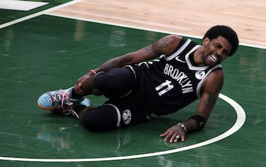 MILWAUKEE, WISCONSIN - JUNE 13: Kyrie Irving #11 of the Brooklyn Nets is injured during the first half of Game Four of the Eastern Conference second round playoff series against the Milwaukee Bucks at the Fiserv Forum on June 13, 2021 in Milwaukee, Wisconsin. NOTE TO USER: User expressly acknowledges and agrees that, by downloading and or using this photograph, User is consenting to the terms and conditions of the Getty Images License Agreement. (Photo by Stacy Revere/Getty Images)