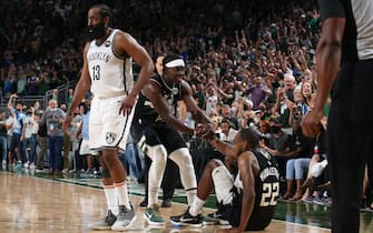 MILWAUKEE, WI - JUNE 17: Jrue Holiday #21 helps up Khris Middleton #22 of the Milwaukee Bucks during Round 2, Game 6 of the 2021 NBA Playoffs on June 17, 2021 at the Fiserv Forum Center in Milwaukee, Wisconsin. NOTE TO USER: User expressly acknowledges and agrees that, by downloading and or using this Photograph, user is consenting to the terms and conditions of the Getty Images License Agreement. Mandatory Copyright Notice: Copyright 2021 NBAE (Photo by Gary Dineen/NBAE via Getty Images).