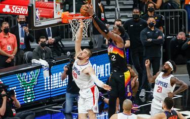 PHOENIX, ARIZONA - JUNE 22: Deandre Ayton #22 of the Phoenix Suns dunks the ball over Ivica Zubac #40 of the LA Clippers  during the fourth quarter in game two of the NBA Western Conference finals in-which the Phoenix Suns defeated the LA Clippers 104-103 at Phoenix Suns Arena on June 22, 2021 in Phoenix, Arizona. NOTE TO USER: User expressly acknowledges and agrees that, by downloading and or using this photograph, User is consenting to the terms and conditions of the Getty Images License Agreement.  (Photo by Christian Petersen/Getty Images)