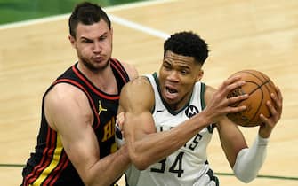 MILWAUKEE, WISCONSIN - JUNE 25: Giannis Antetokounmpo #34 of the Milwaukee Bucks is pressured by Danilo Gallinari #8 of the Atlanta Hawks during the first half in game two of the Eastern Conference Finals at Fiserv Forum on June 25, 2021 in Milwaukee, Wisconsin. NOTE TO USER: User expressly acknowledges and agrees that, by downloading and or using this photograph, User is consenting to the terms and conditions of the Getty Images License Agreement. (Photo by Patrick McDermott/Getty Images)