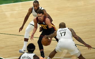 MILWAUKEE, WISCONSIN- JUNE 25: Trae Young #11 of the Atlanta Hawks is pressured by P.J. Tucker #17 of the Milwaukee Bucks during the second half in game two of the Eastern Conference Finals at Fiserv Forum on June 25, 2021 in Milwaukee, Wisconsin. NOTE TO USER: User expressly acknowledges and agrees that, by downloading and or using this photograph, User is consenting to the terms and conditions of the Getty Images License Agreement. (Photo by Patrick McDermott/Getty Images)