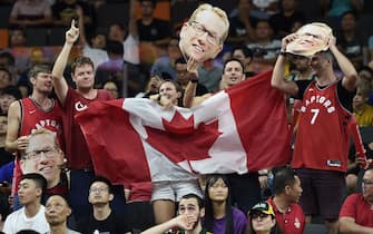 Canadian fans hold their national flag along with the portraits of team's coach Nick Nurse during the Basketball World Cup Group H game between Canada and Australia in Dongguan on September 1, 2019. (Photo by Ye Aung Thu / AFP)        (Photo credit should read YE AUNG THU/AFP via Getty Images)