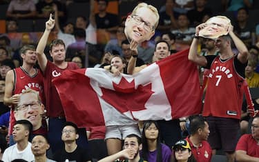 Canadian fans hold their national flag along with the portraits of team's coach Nick Nurse during the Basketball World Cup Group H game between Canada and Australia in Dongguan on September 1, 2019. (Photo by Ye Aung Thu / AFP) (Photo credit should read YE AUNG THU/AFP via Getty Images)