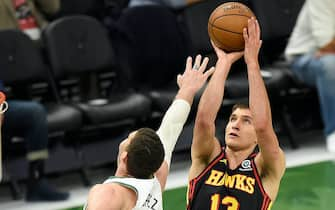 MILWAUKEE, WISCONSIN - JULY 01: Bogdan Bogdanovic #13 of the Atlanta Hawks shoots against Brook Lopez #11 of the Milwaukee Bucks during the first half in Game Five of the Eastern Conference Finals at Fiserv Forum on July 01, 2021 in Milwaukee, Wisconsin. NOTE TO USER: User expressly acknowledges and agrees that, by downloading and or using this photograph, User is consenting to the terms and conditions of the Getty Images License Agreement. (Photo by Patrick McDermott/Getty Images)