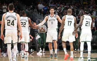 1233761370 MILWAUKEE, WI - JULY 1: Brook Lopez #11 hi-fives Khris Middleton #22, P.J. Tucker #17, Pat Connaughton #24 and Jrue Holiday #21 of the Milwaukee Bucks during Game 5 of the Eastern Conference Finals of the 2021 NBA Playoffs on July 1, 2021 at the Fiserv Forum Center in Milwaukee, Wisconsin. NOTE TO USER: User expressly acknowledges and agrees that, by downloading and or using this Photograph, user is consenting to the terms and conditions of the Getty Images License Agreement. Mandatory Copyright Notice: Copyright 2021 NBAE (Photo by Gary Dineen/NBAE via Getty Images).